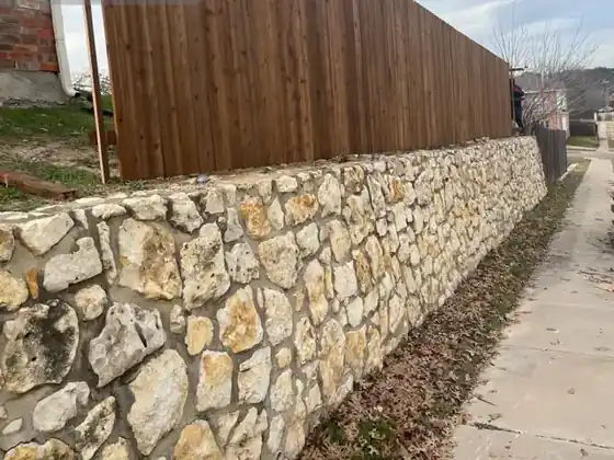 Wood fence on stone wall &mdash; Fort Worth, TX